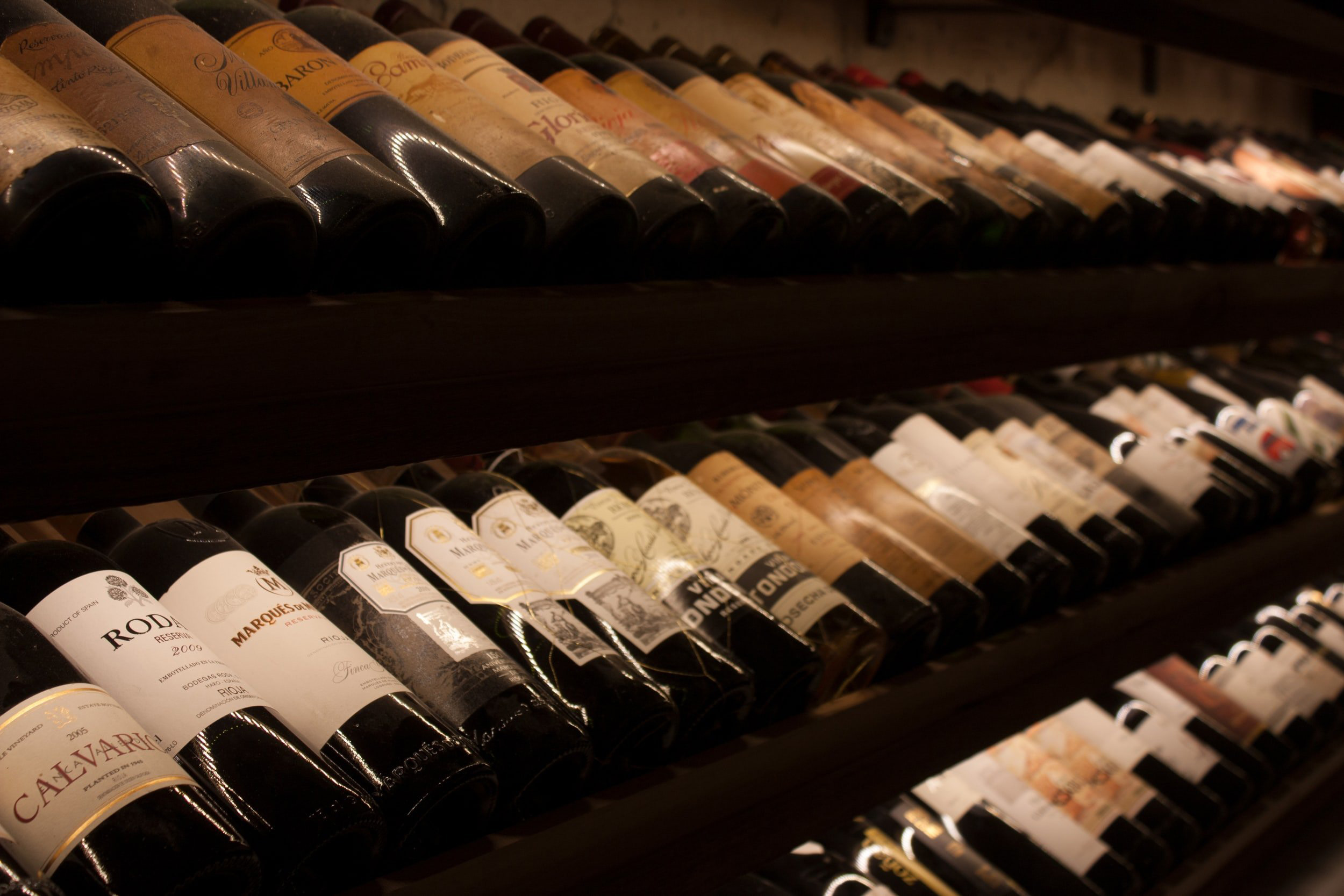 rows of wines at a wine store from a front side view